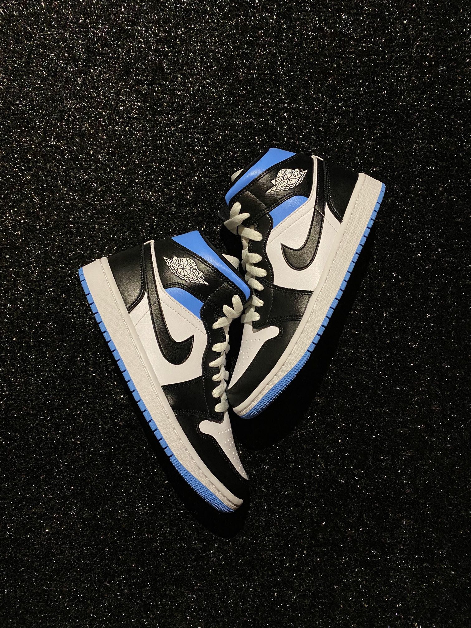 A pair of sneakers that are on the ground - Air Jordan 1, Air Jordan