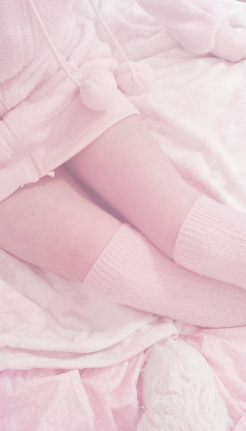 A woman in pink clothing and socks - Soft pink