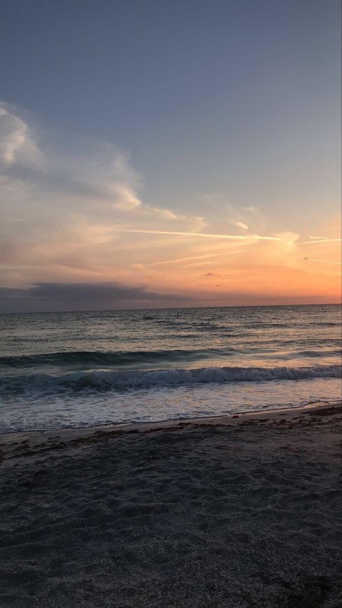 A person standing on the beach at sunset - Florida