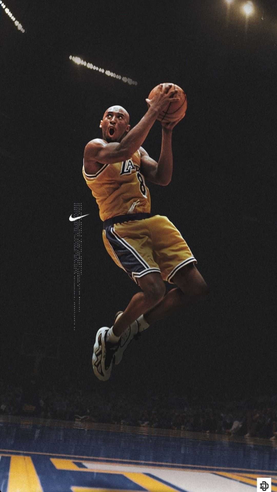 A man in yellow jersey dunking the basketball - Kobe Bryant