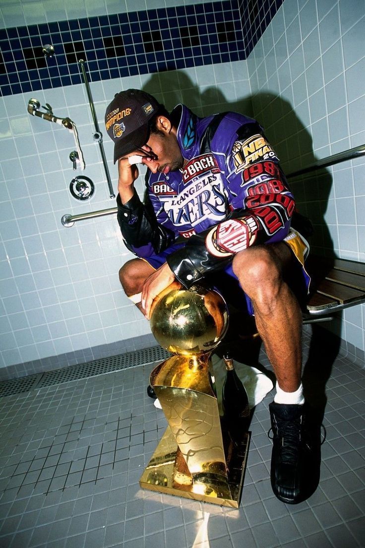 Kobe Bryant sitting on a toilet with the NBA championship trophy. - Kobe Bryant