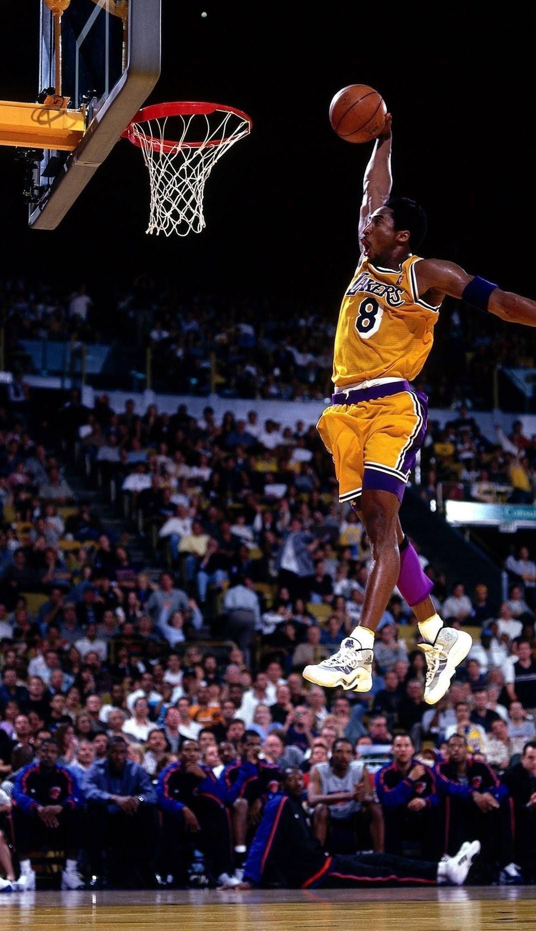 A man in yellow jumps for the  - Kobe Bryant