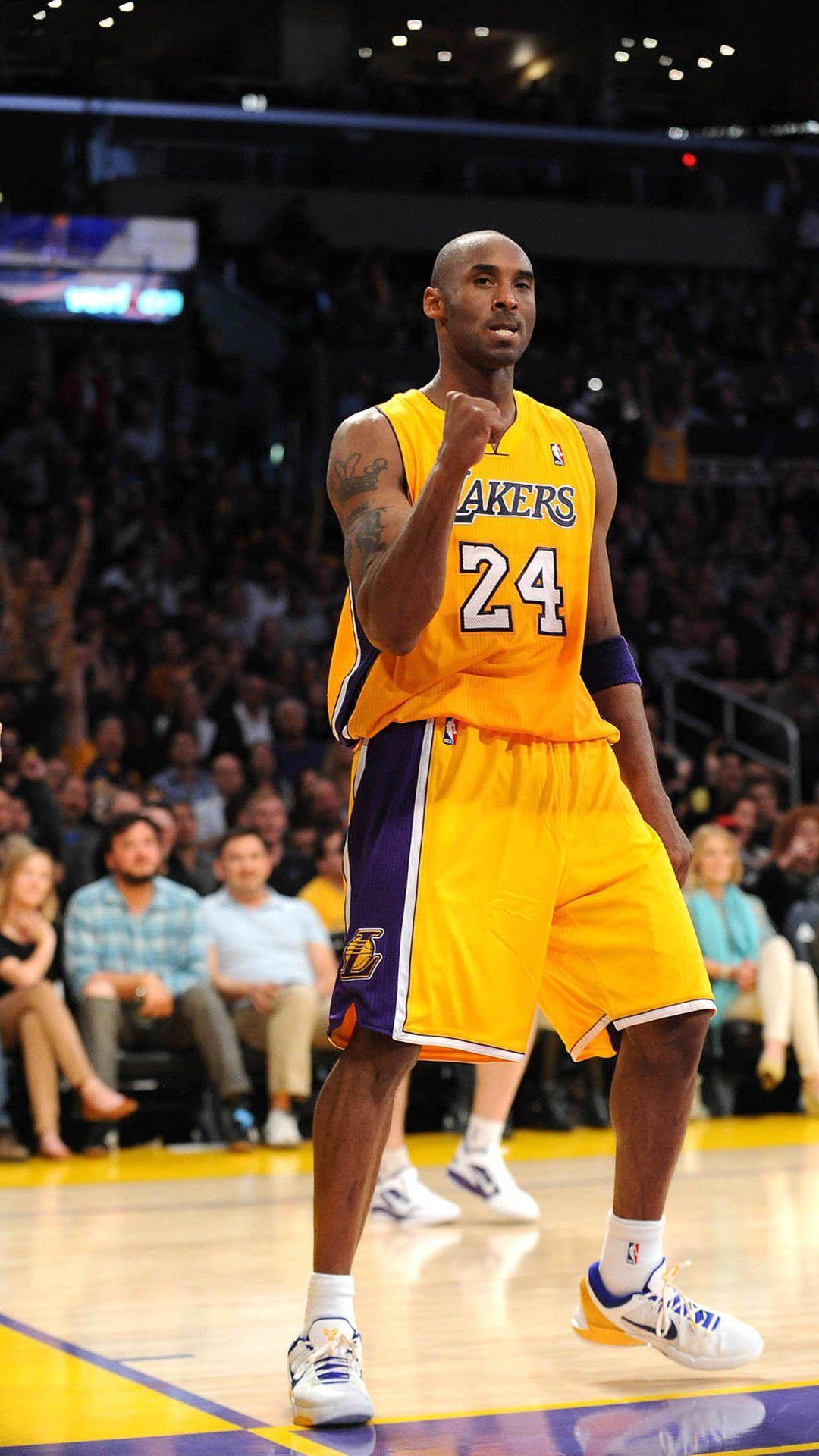 A man in basketball uniform standing on the court - Kobe Bryant