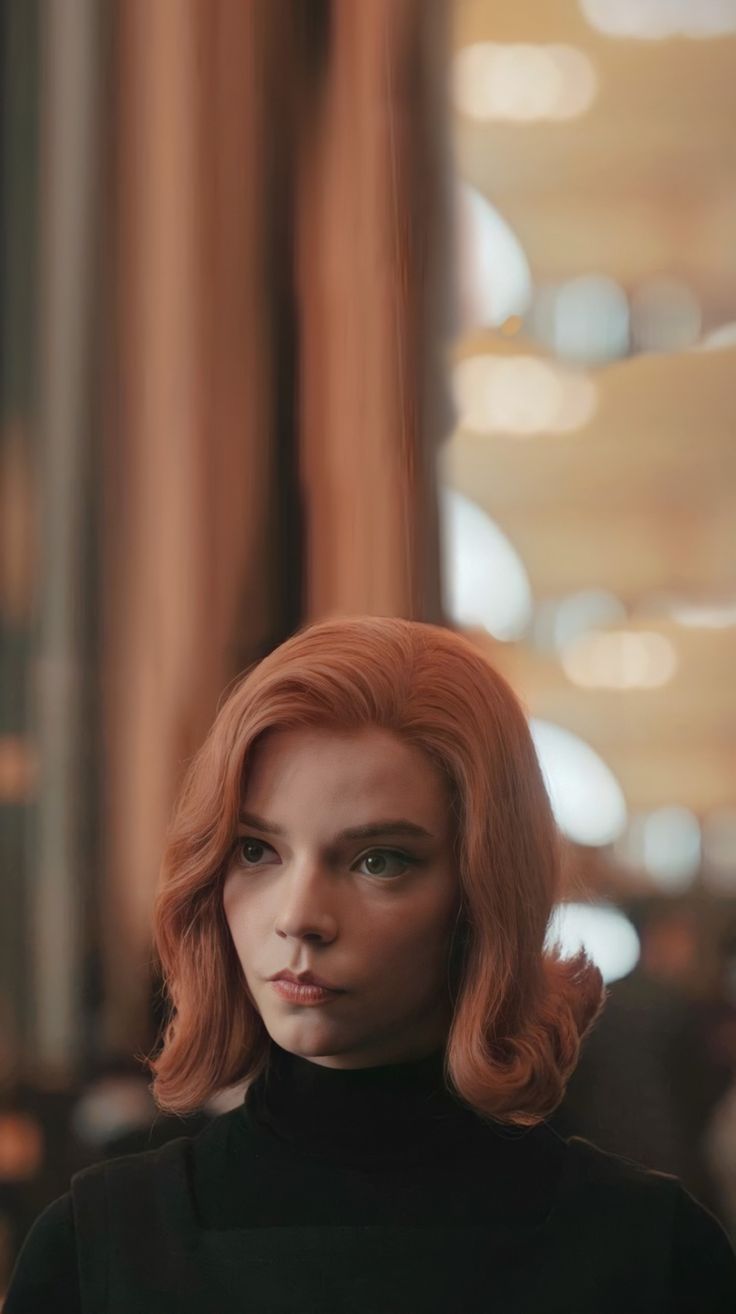 A woman with red hair and black clothes - Anya Taylor-Joy