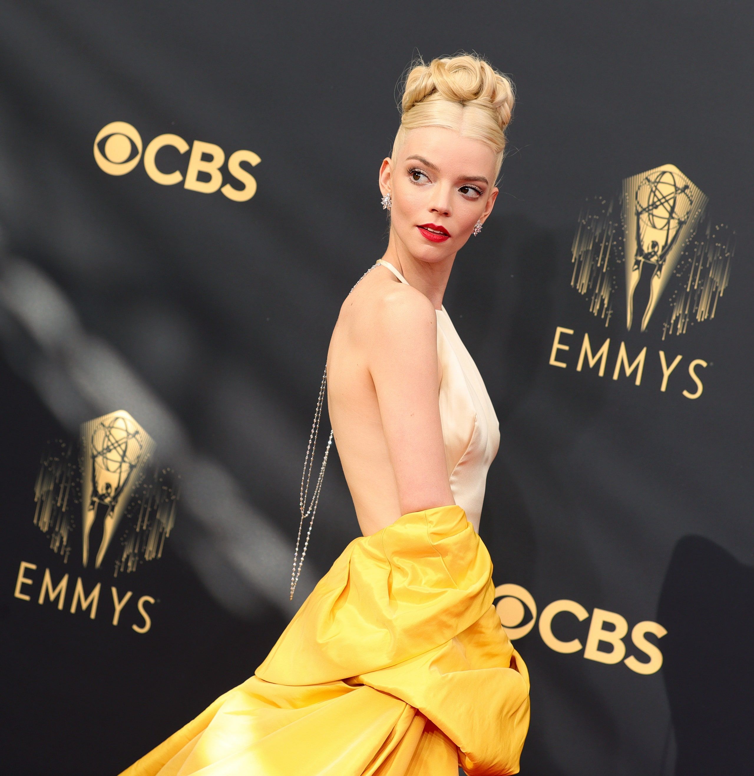 A woman in yellow dress posing on the red carpet - Anya Taylor-Joy