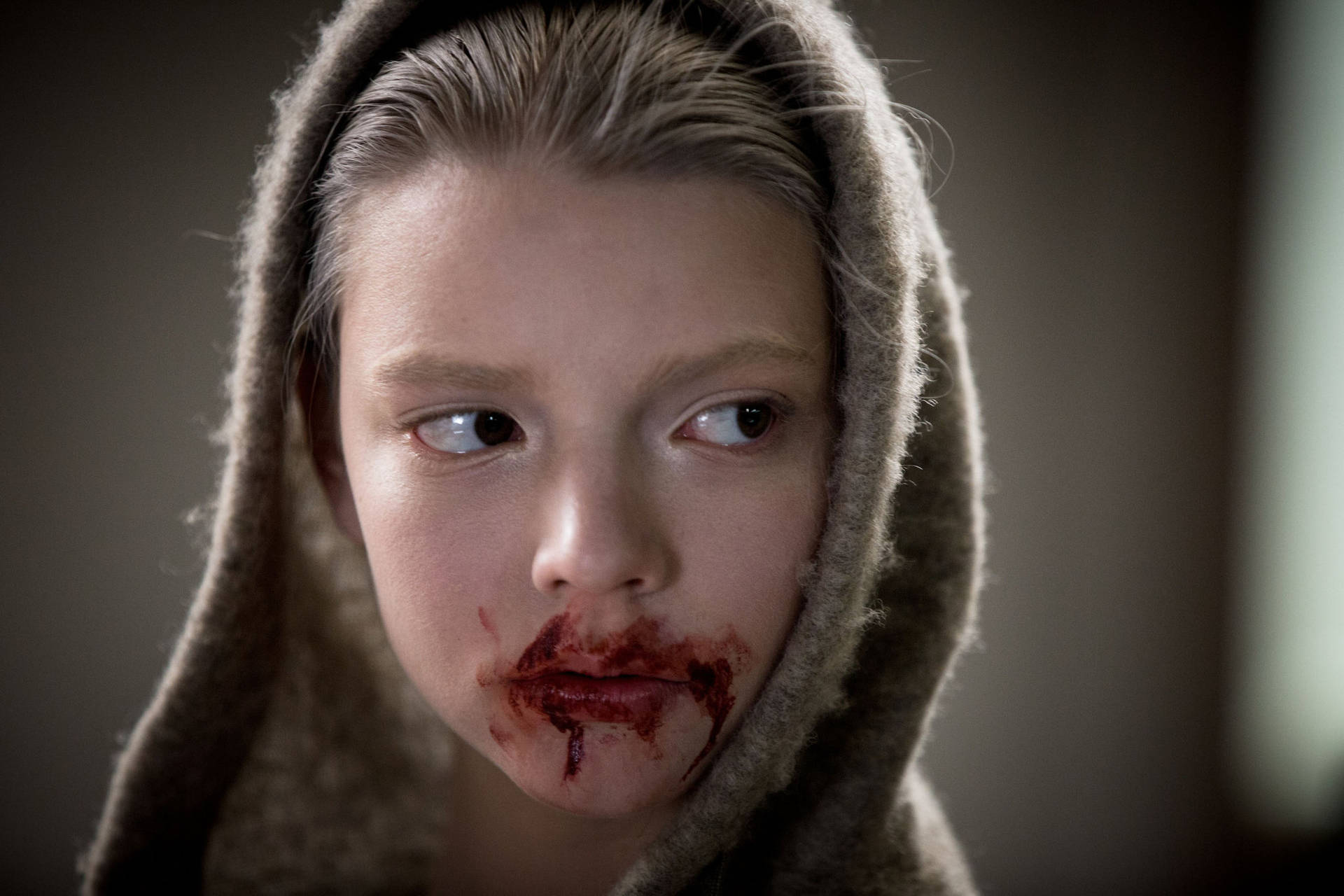 A woman with blood on her face - Anya Taylor-Joy