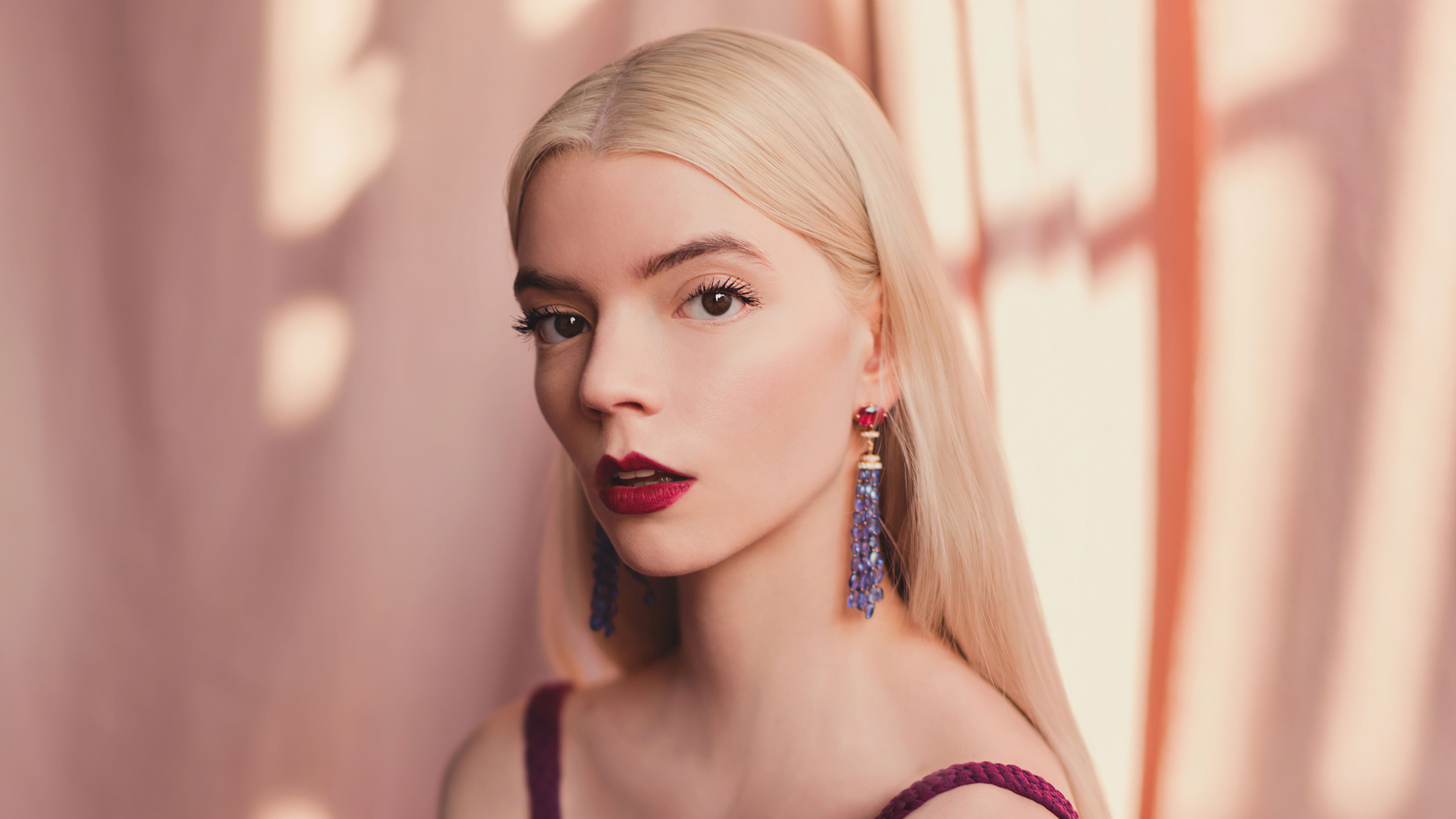 A blonde woman with long hair and red lipstick - Anya Taylor-Joy