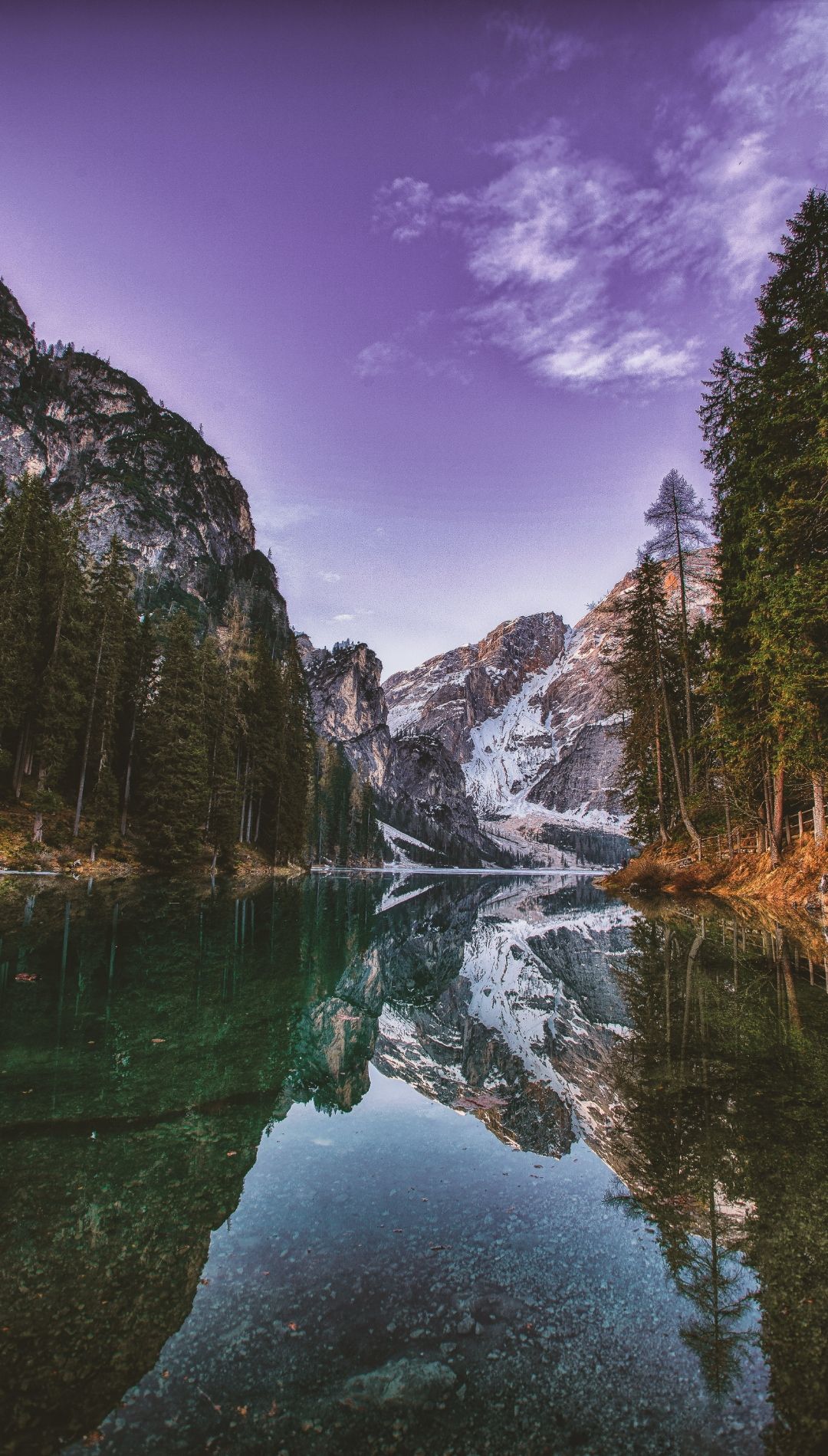 A lake with trees and mountains in the background - River