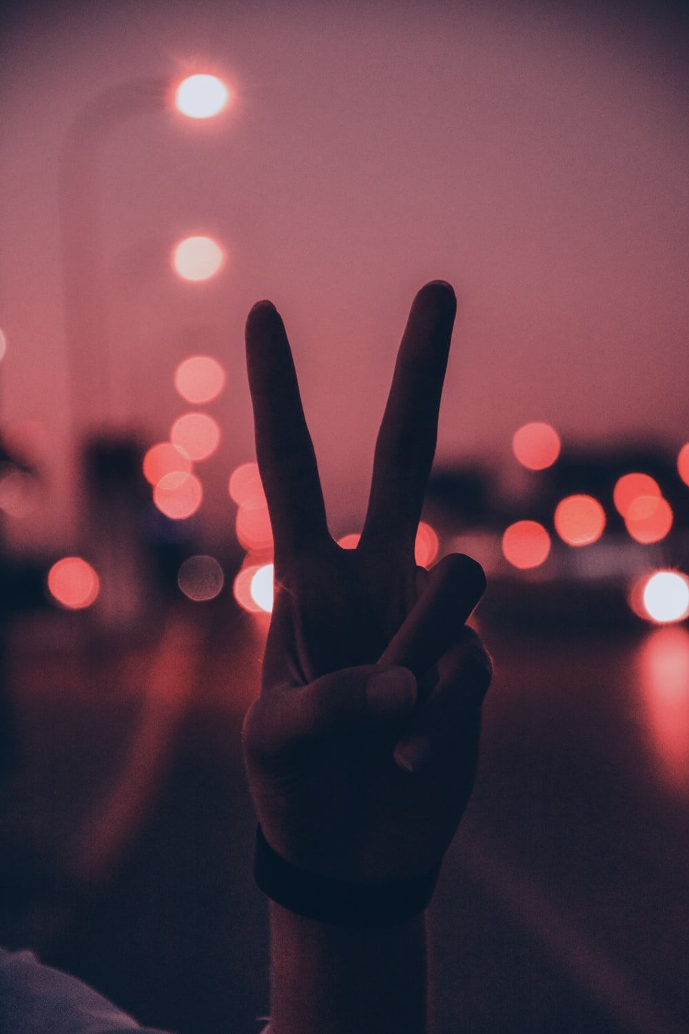A person making the peace sign with their fingers - Peace