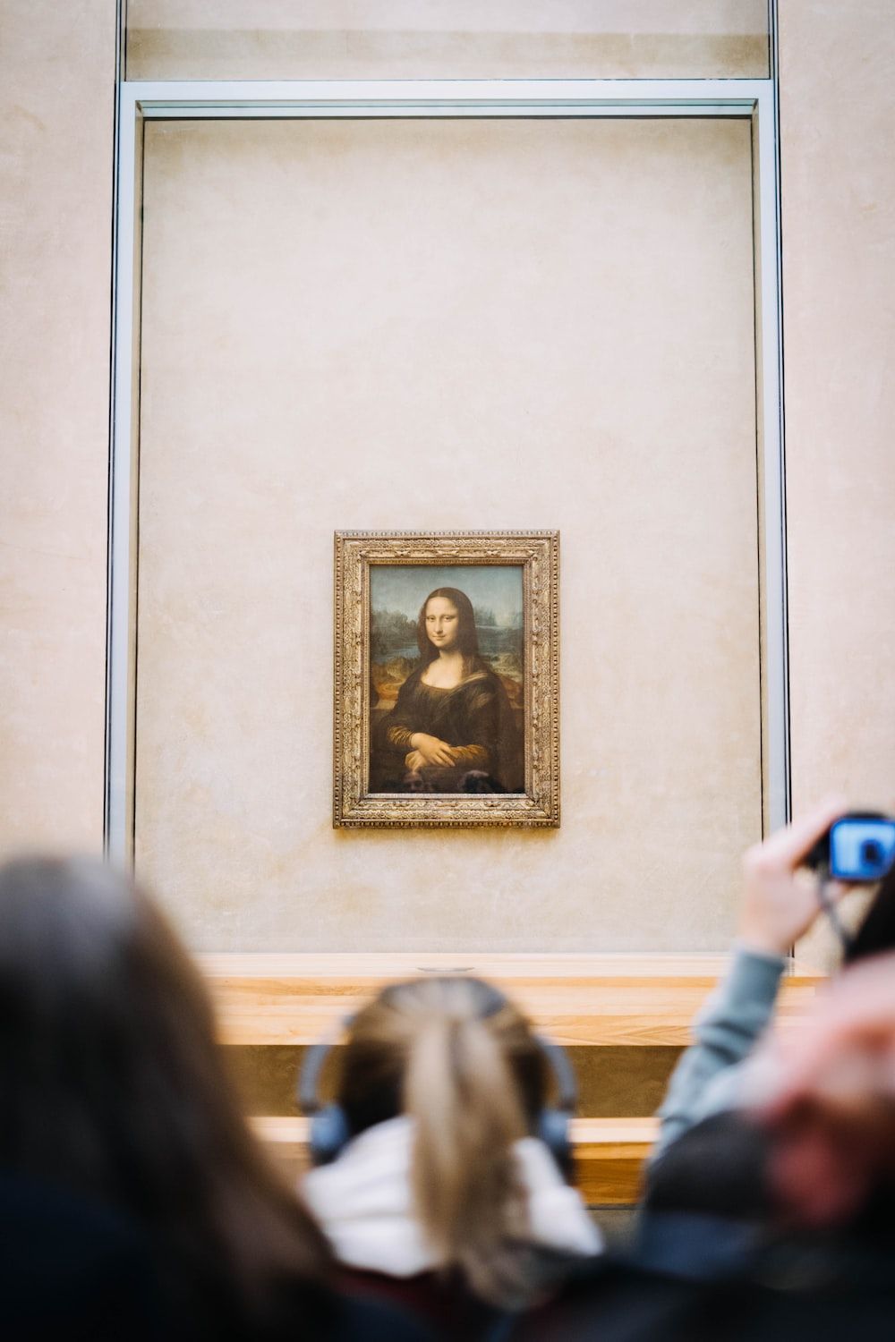 People taking photos of the Mona Lisa painting at the Louvre Museum in Paris. - Mona Lisa