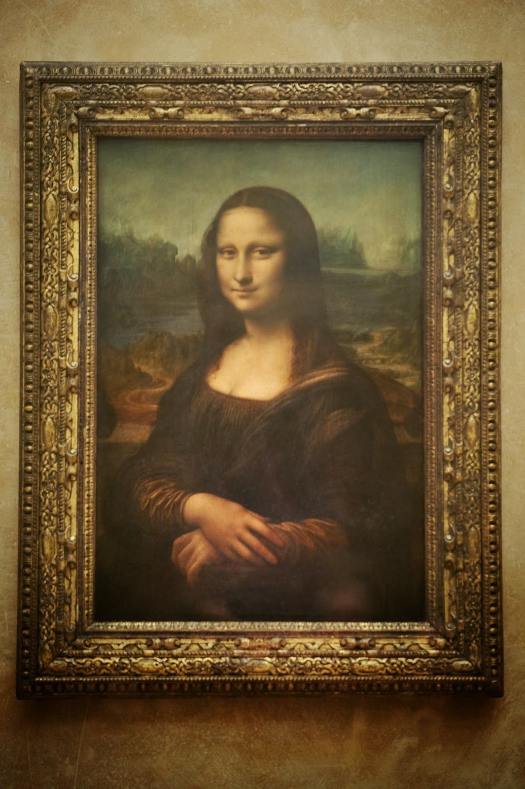 A painting of mona lisa is displayed on the wall - Mona Lisa