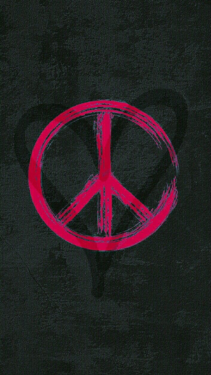 A red peace sign on a black background - Peace