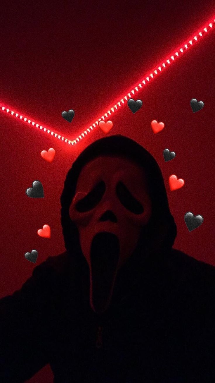 Aesthetic wallpaper for phone of a person wearing a scream mask with a red background and heart shaped lights. - Ghostface