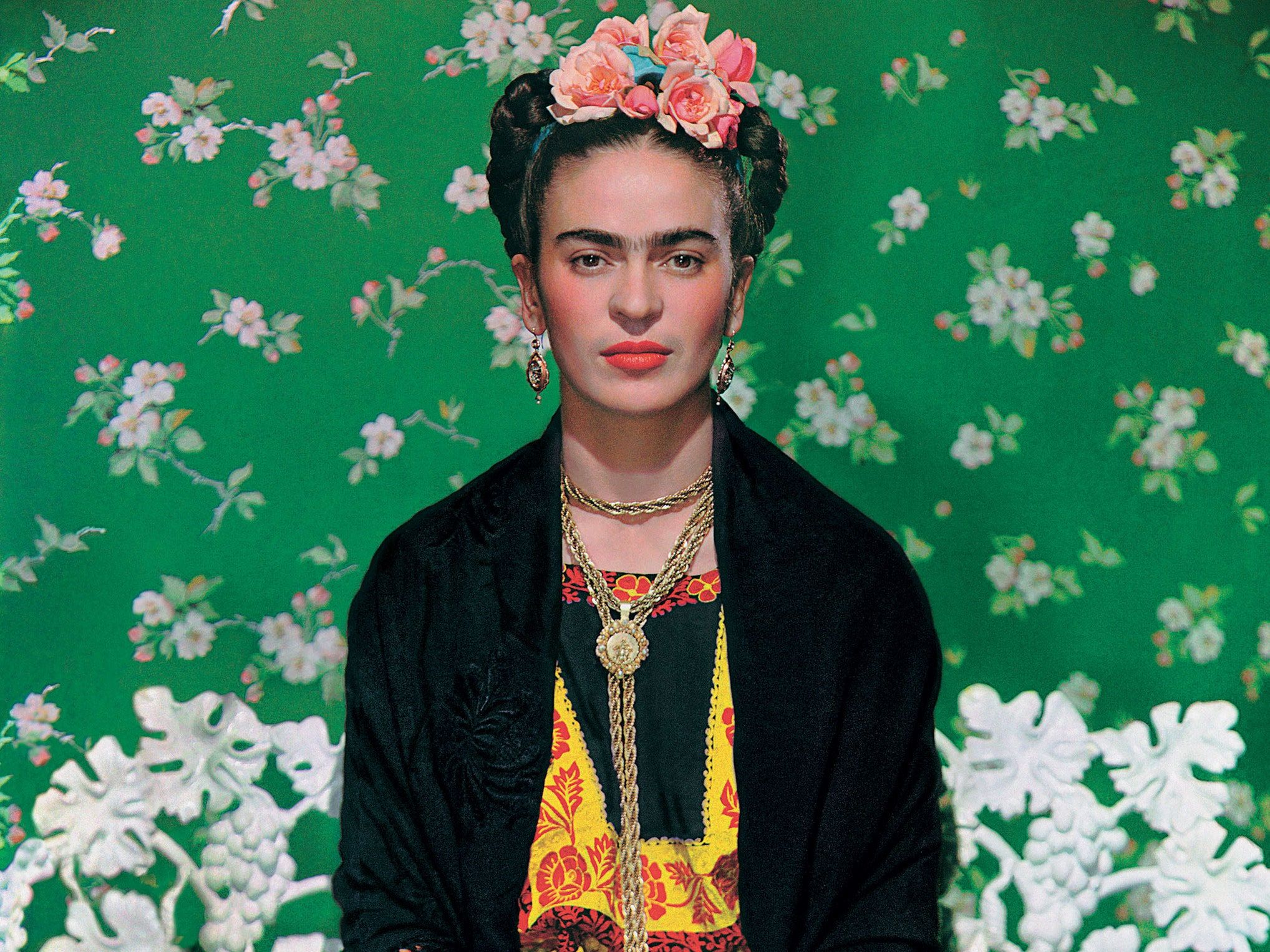A woman in traditional mexican clothing sitting on the floor - Frida Kahlo