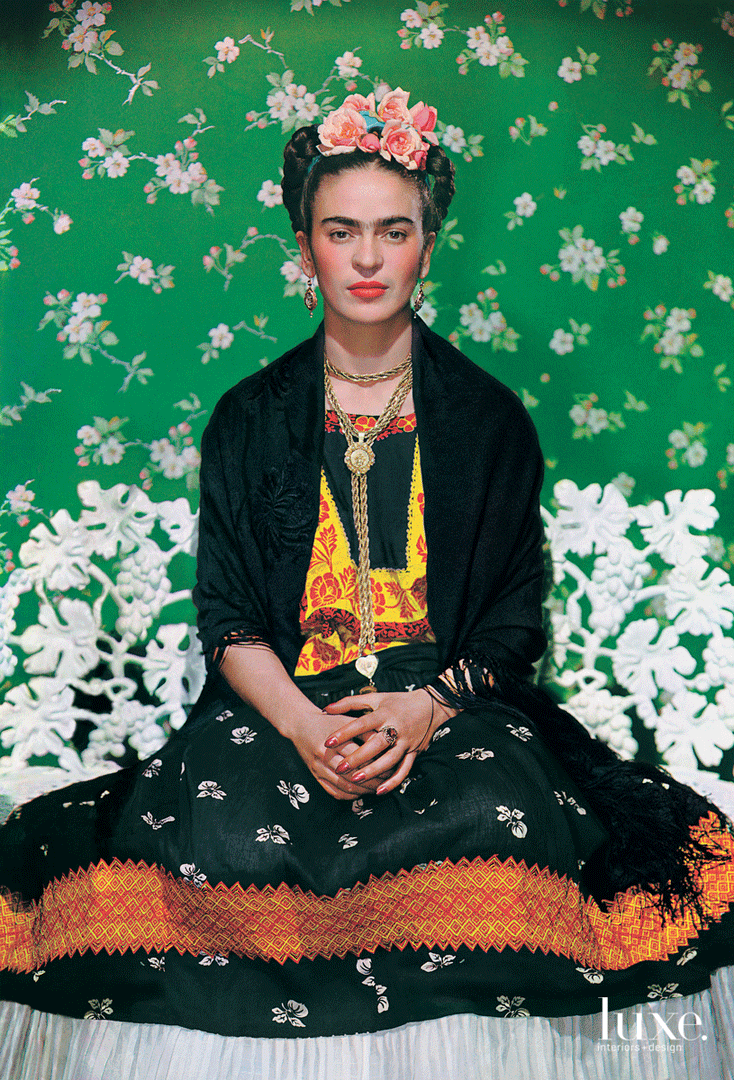 Frida Kahlo in traditional Mexican dress, with a green floral background. - Frida Kahlo