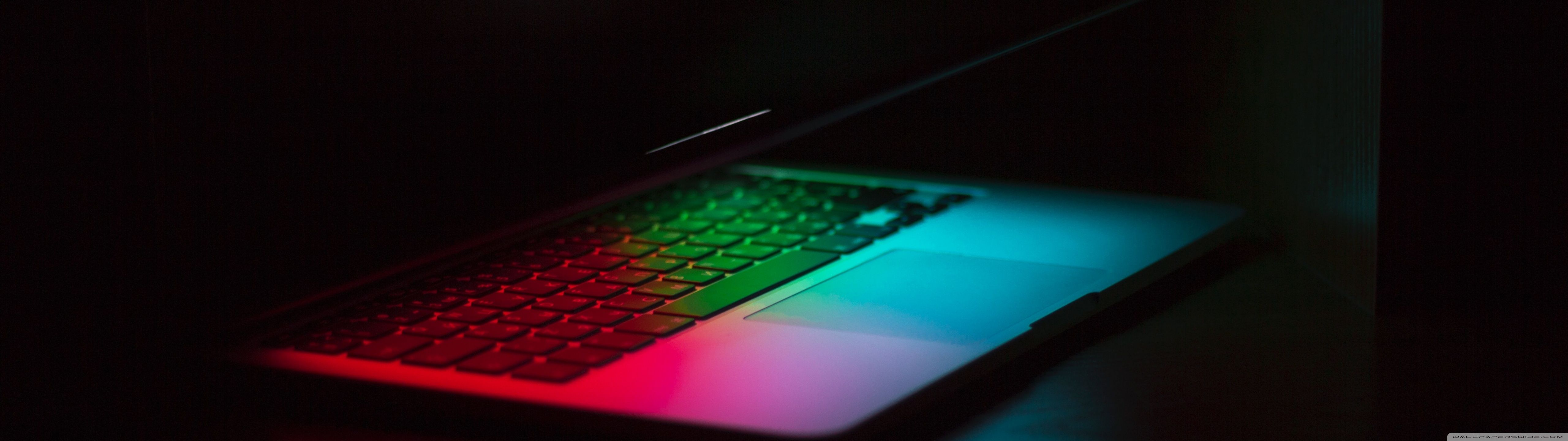 A laptop with a colorful keyboard - 5120x1440