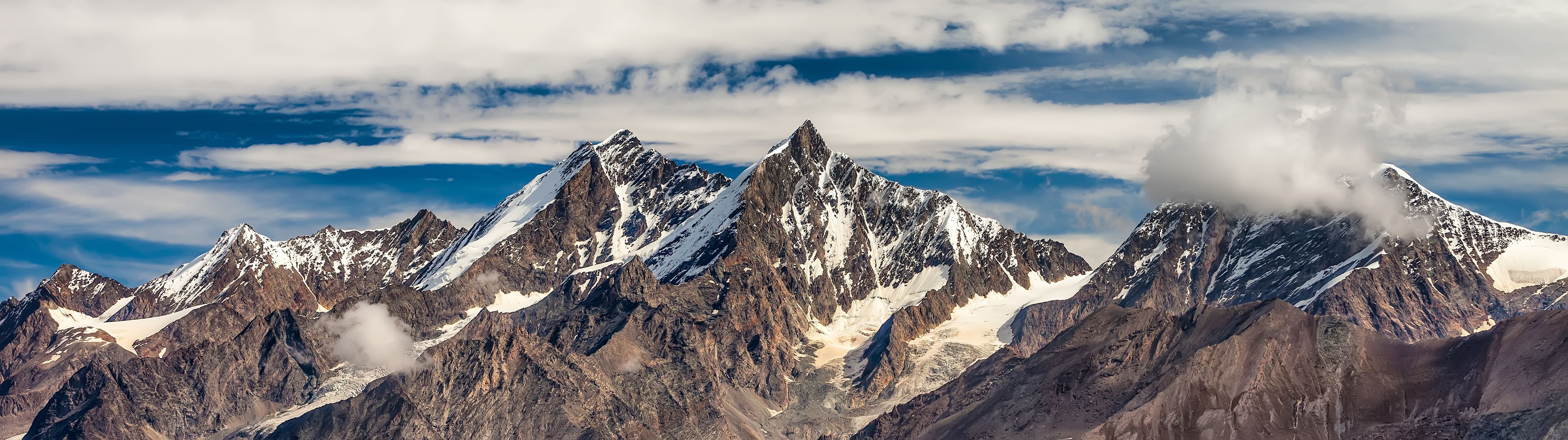 A mountain with snow on top of it - 5120x1440