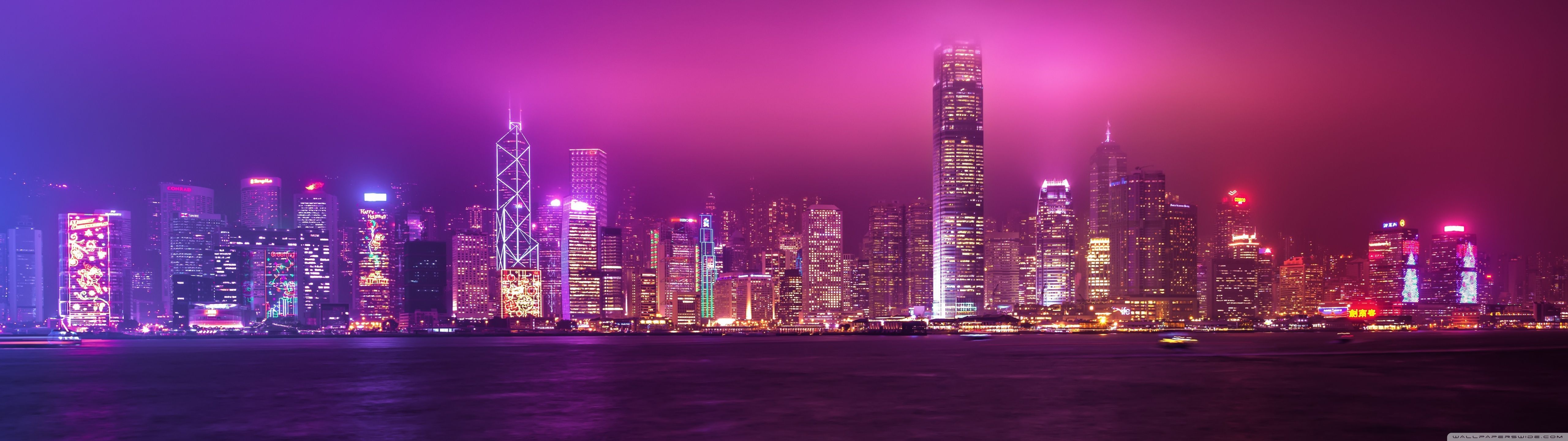 Hong Kong skyline at night with purple and pink hues - 5120x1440