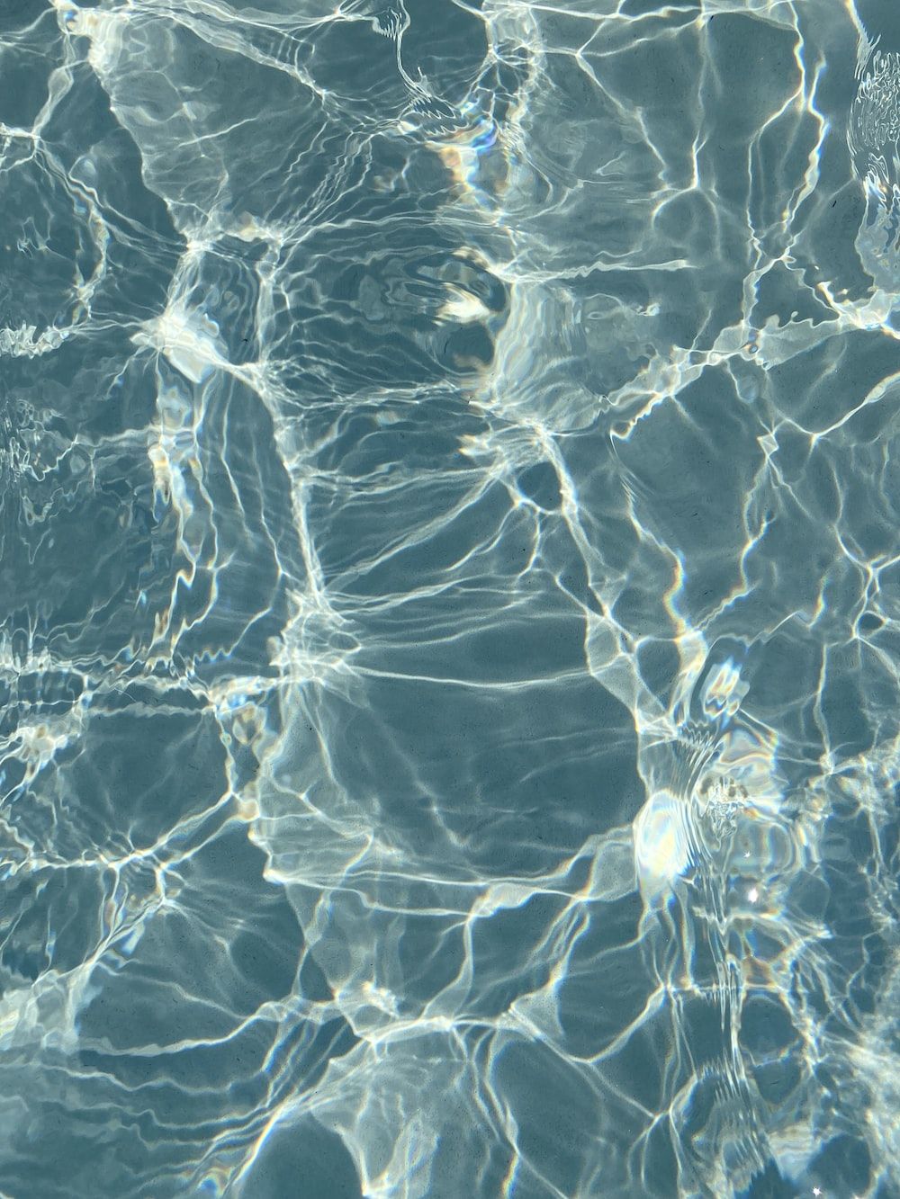 Water in a pool with light reflecting on it - Bling