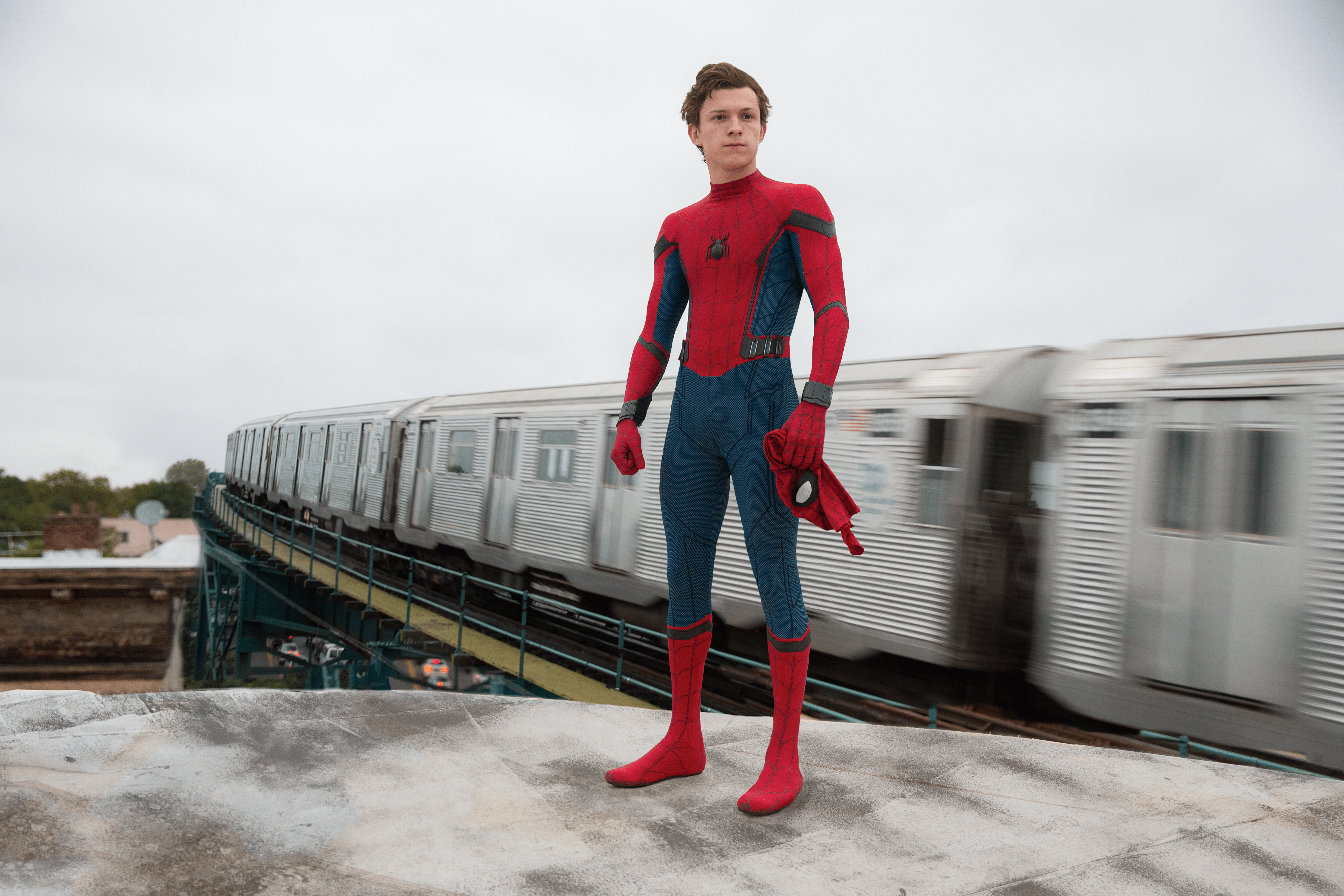 Tom Holland as Spider-Man in front of a train - Tom Holland
