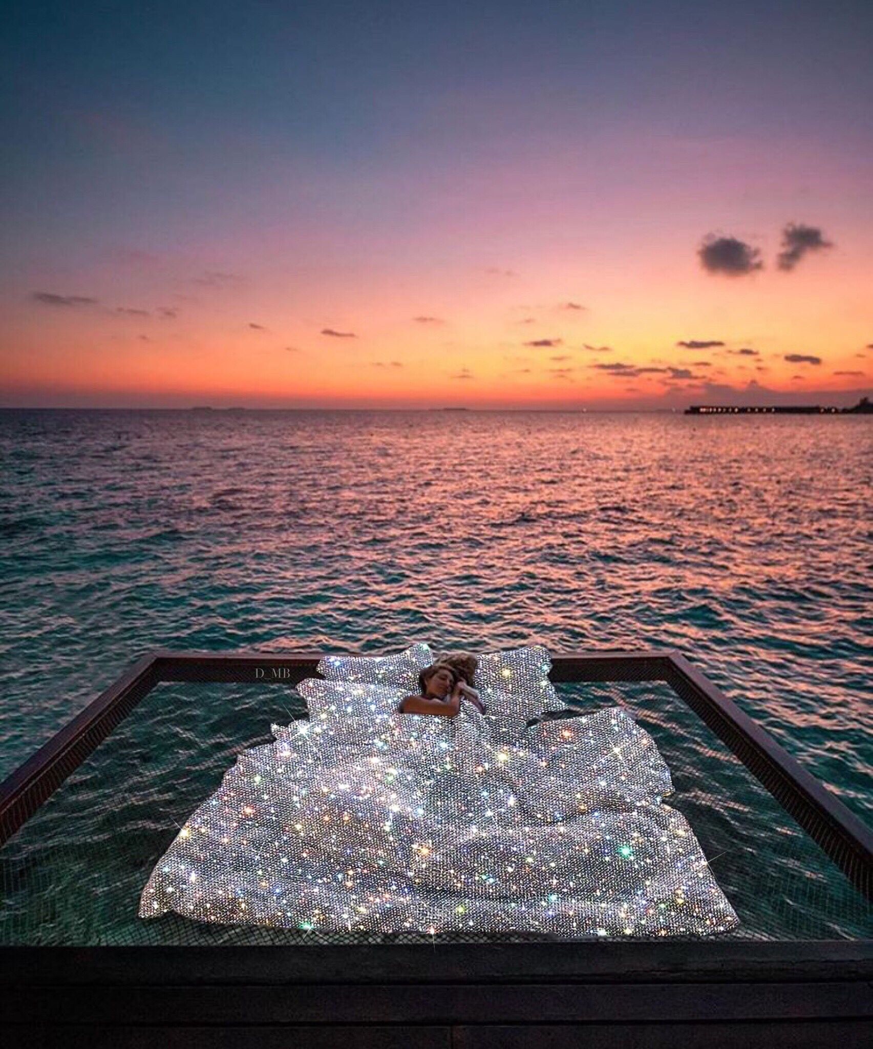 A woman lying on a giant inflatable bed in the middle of the ocean - Bling, glitter