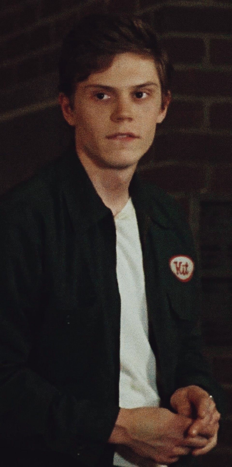 A man in green jacket and white shirt - Evan Peters