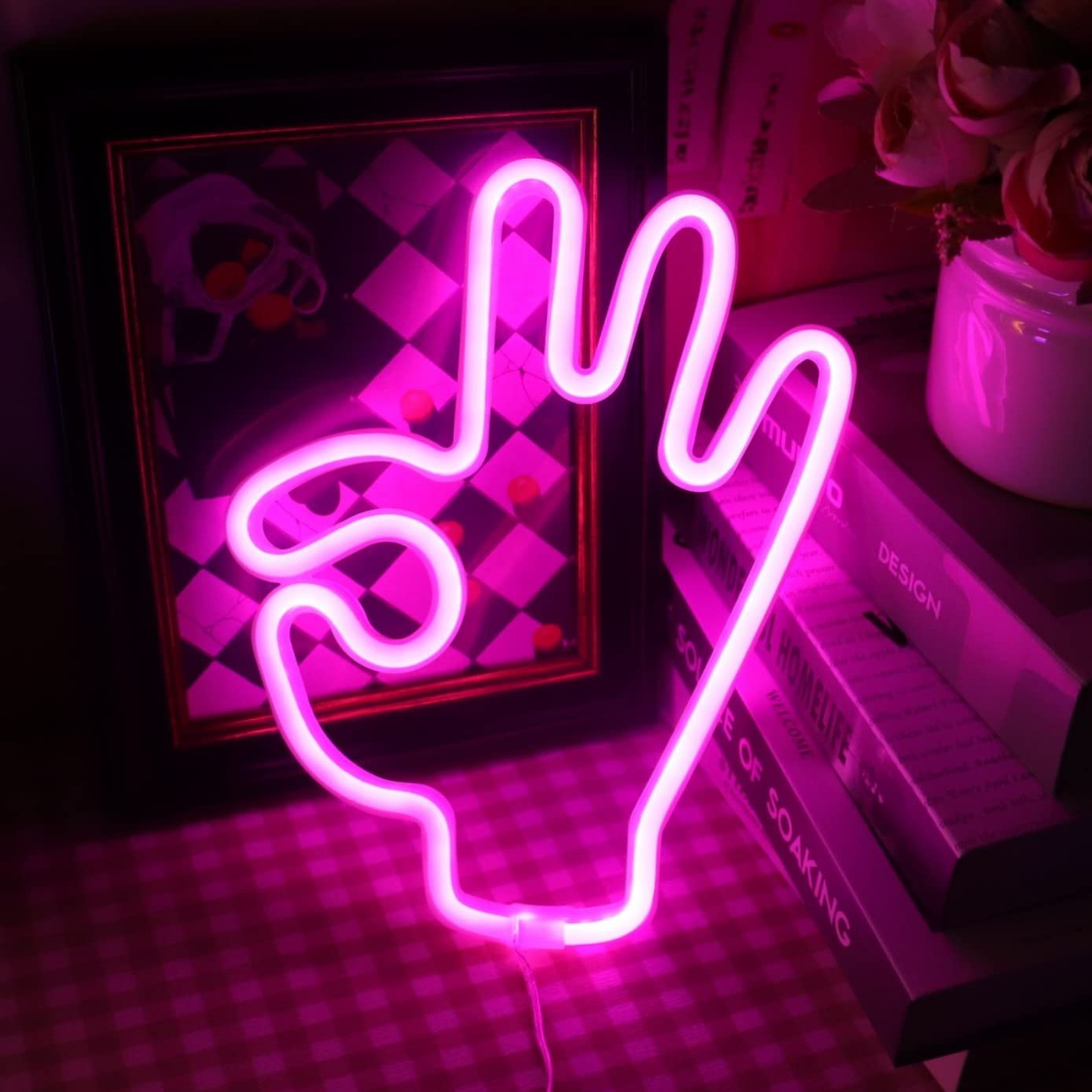 A neon sign that is pink and has the peace symbol on it - Light pink