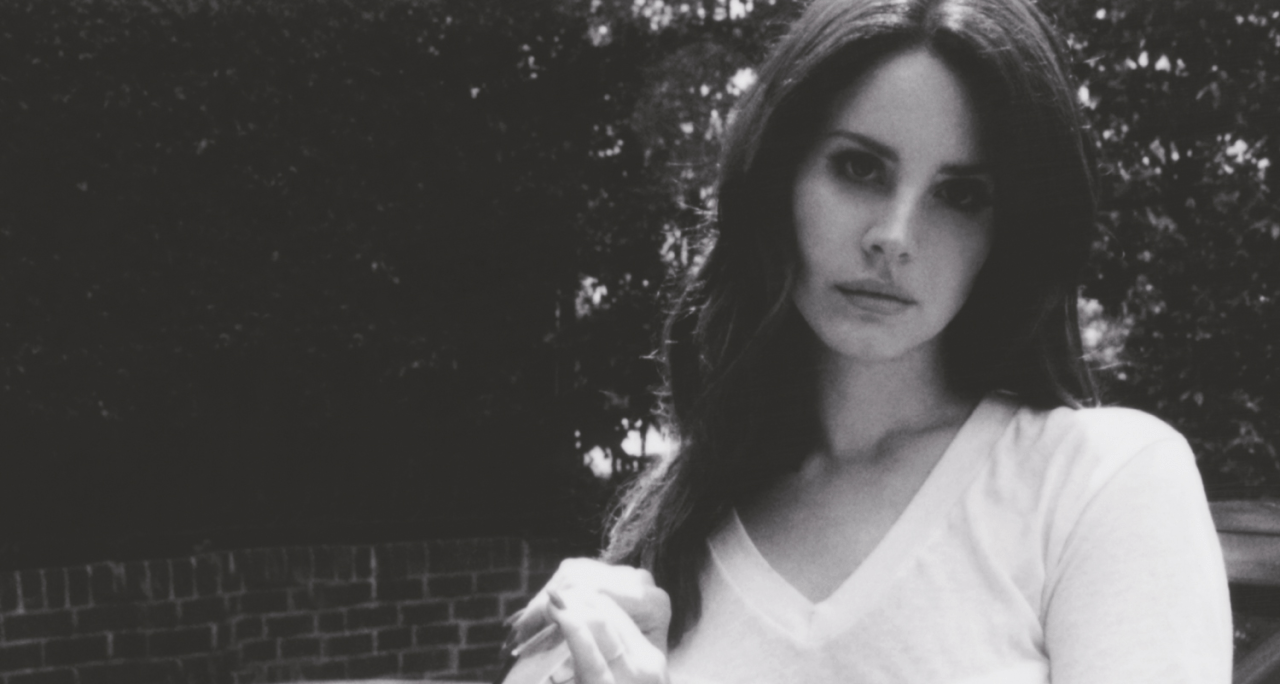 A woman in white shirt and black pants - Lana Del Rey
