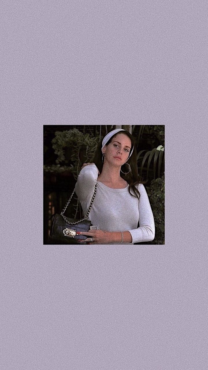A woman in white shirt holding purse - Lana Del Rey