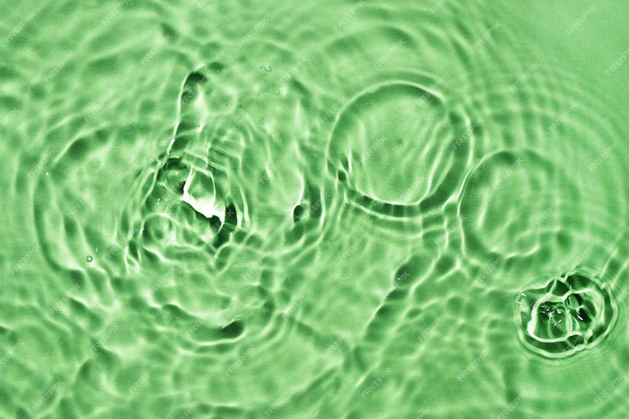 Premium Photo. Light green water surface texture with splashes and bubbles abstract background for natural beauty products green water splashes wallpaper