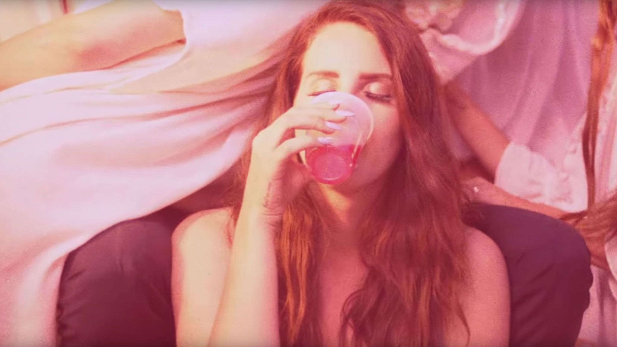 A woman drinking from the bottle - Lana Del Rey