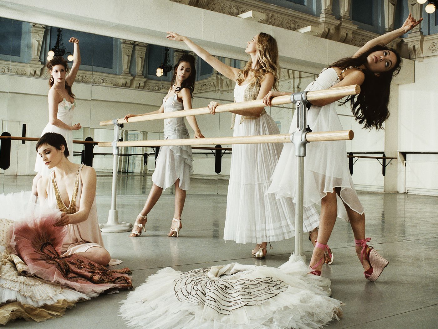 Five women in ballerina costumes posing in a dance studio. - Ballet