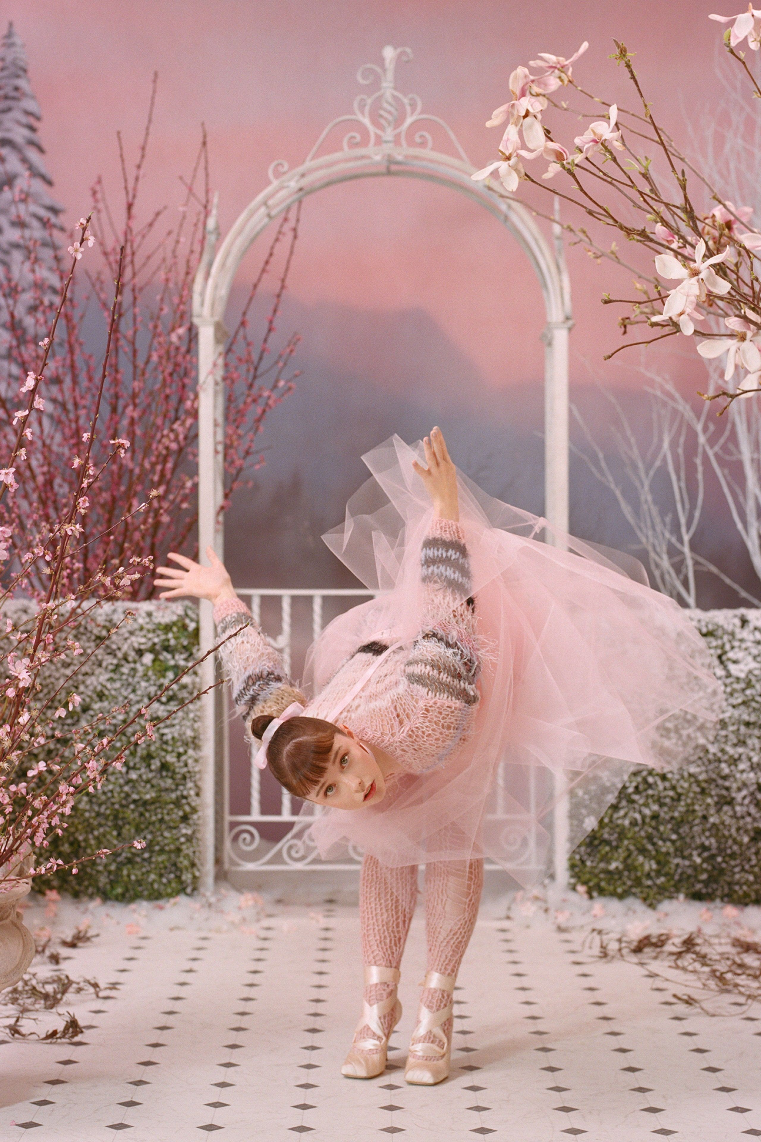 A woman in a pink dress and pink shoes dances in a pink room. - Ballet