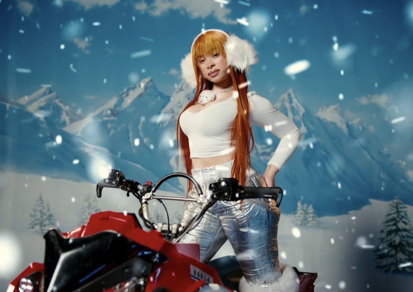 A woman with long red hair wearing a white top and sliver pants sitting on a red motorcycle in the snow. - Ice Spice