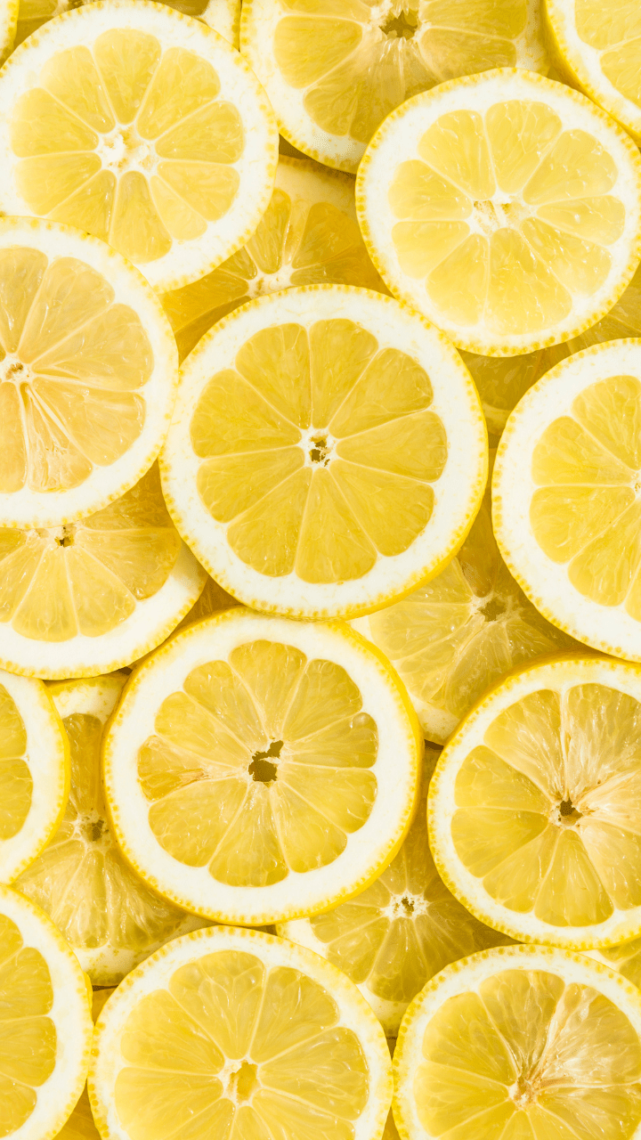 A close up of many lemon slices overlapping each other. - Light yellow, lemon