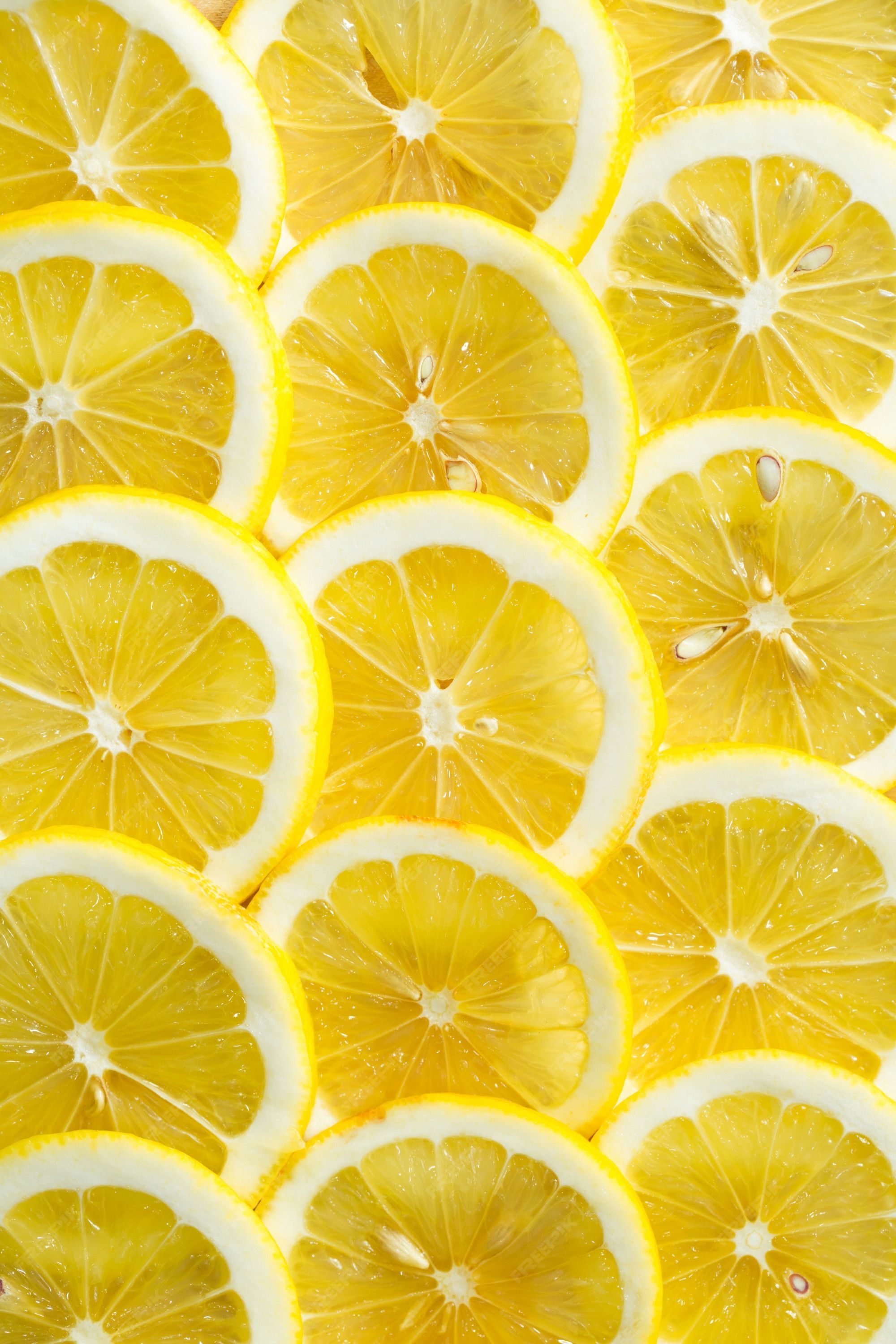 Premium Photo. A slices of fresh yellow lemon texture background pattern