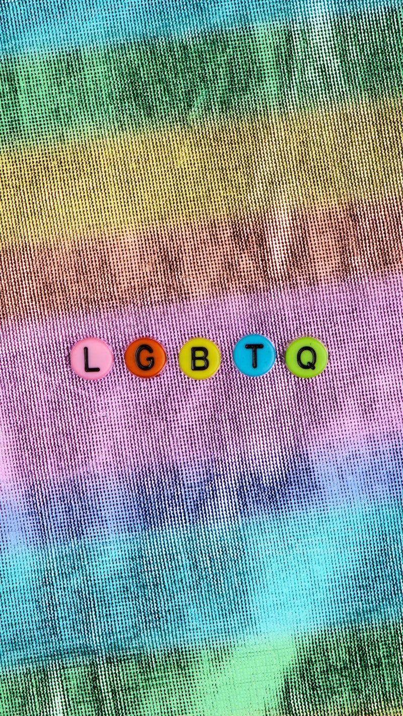 The word LGBTQ spelled out in letter beads on a tie dye background - LGBT
