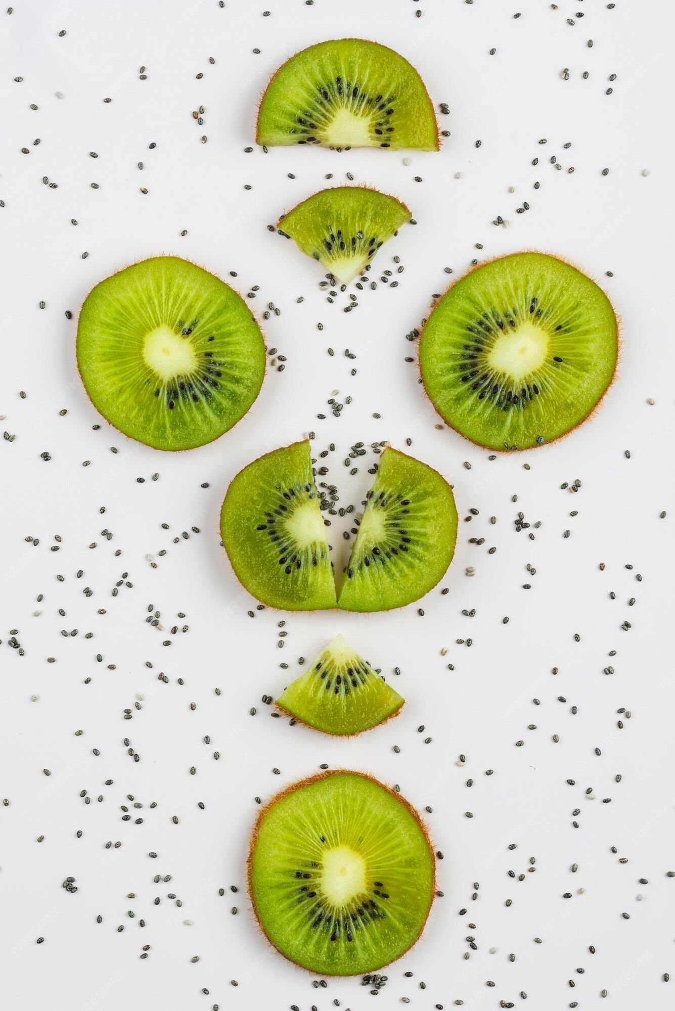 Sliced kiwi fruit with chia seeds on a white background - Kiwi