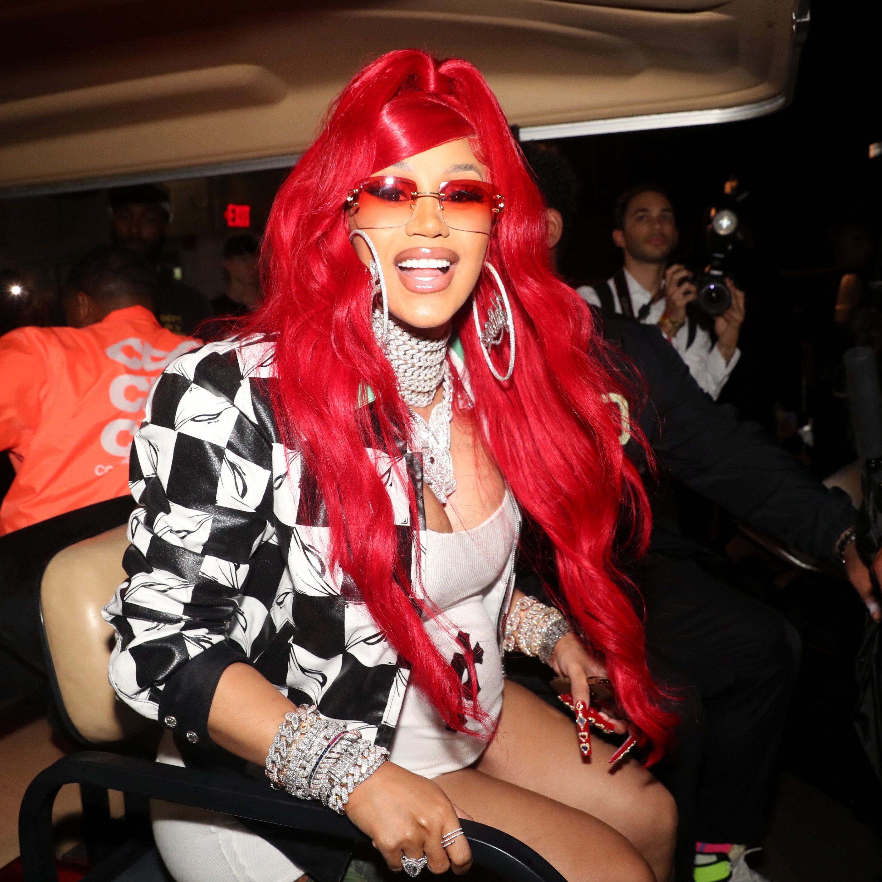 A woman with red hair and glasses - Cardi B