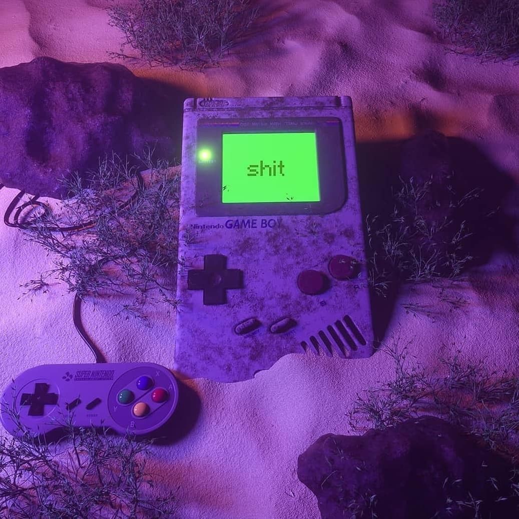 A purple game controller and an old gaming system - Game Boy