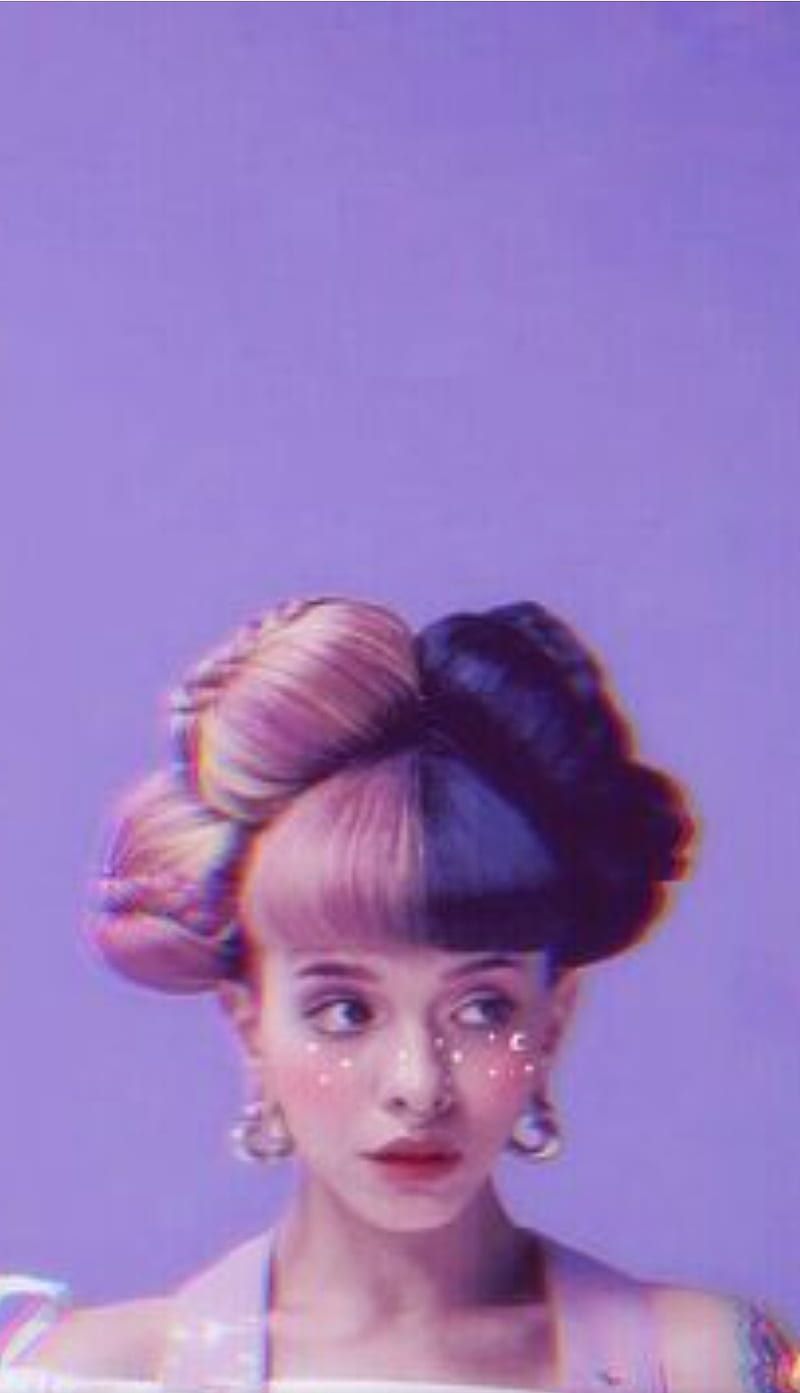 A woman with a colorful hair and makeup on a purple background - Melanie Martinez