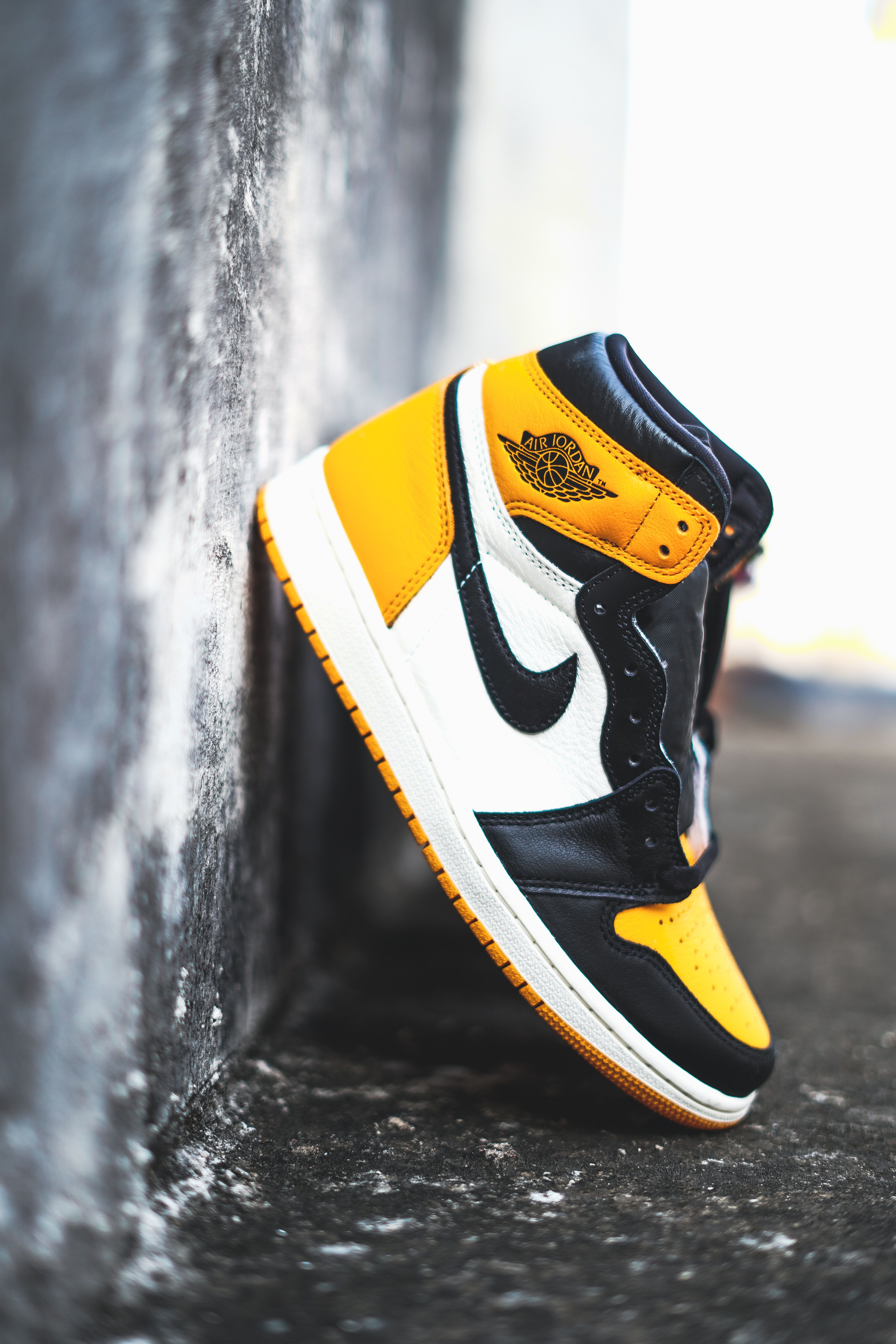 A pair of sneakers are on the ground - Air Jordan 1