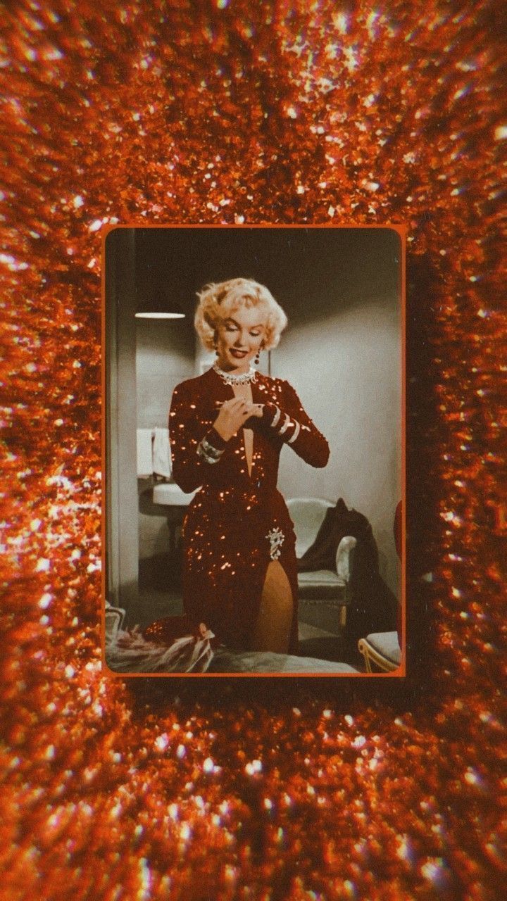 A woman in red is holding up her hair - Marilyn Monroe