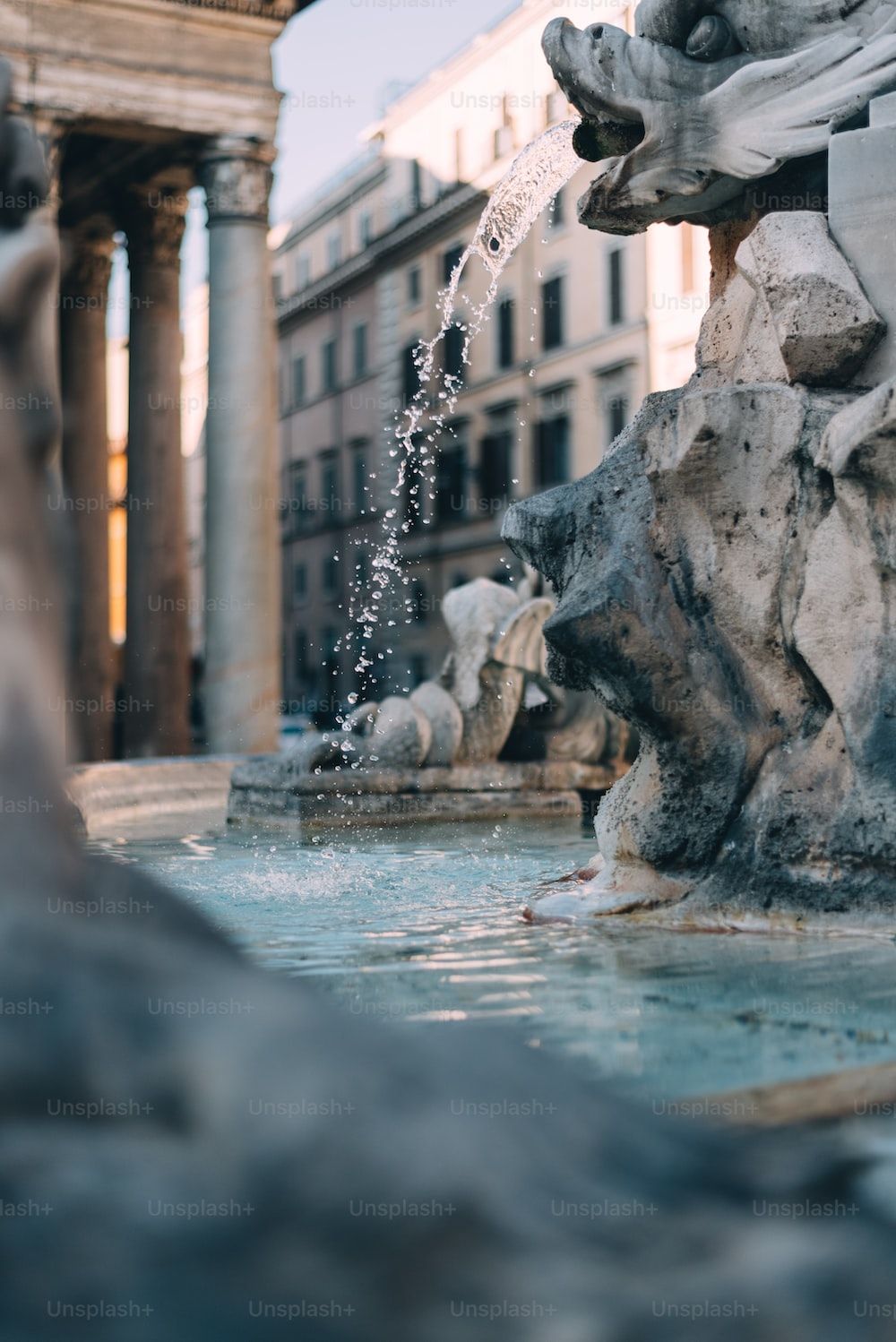 A fountain in the middle of some buildings - Italy