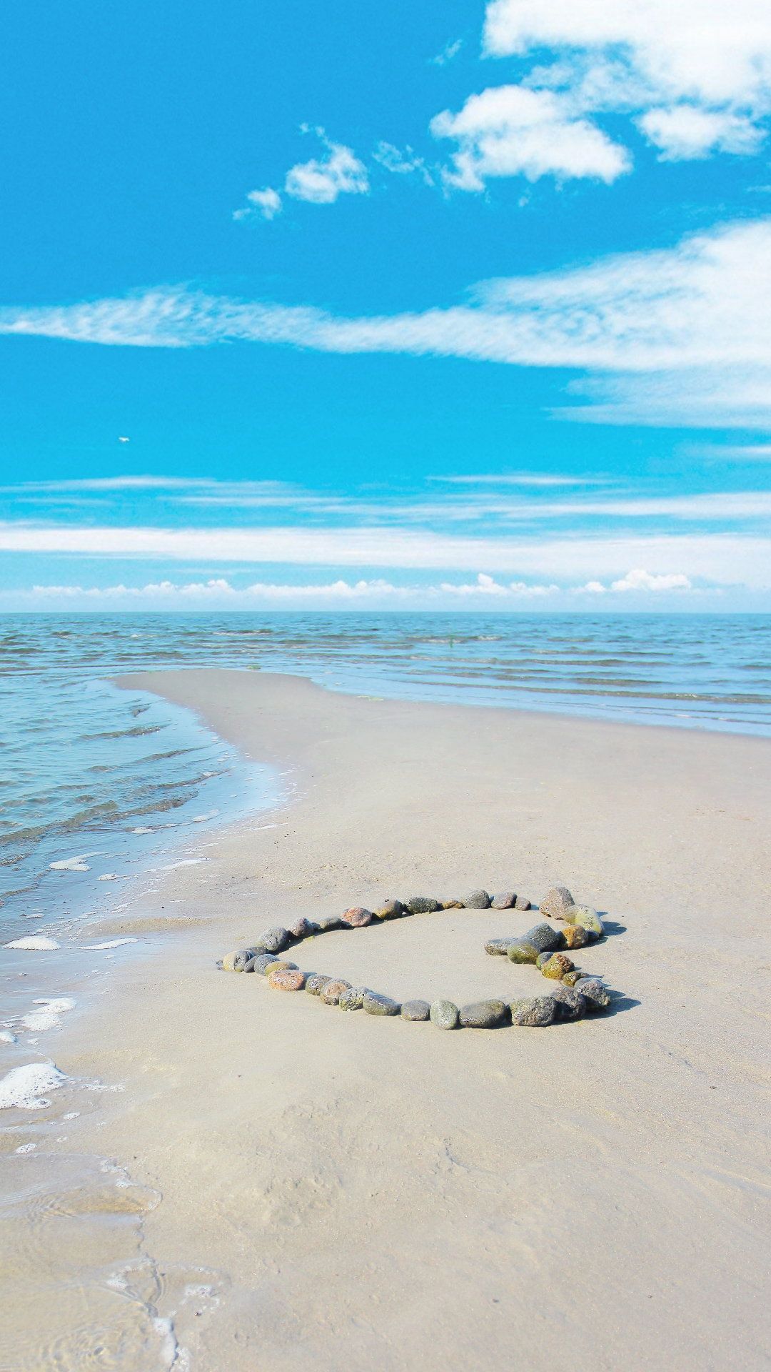 A heart shaped rock formation on the beach - Beach