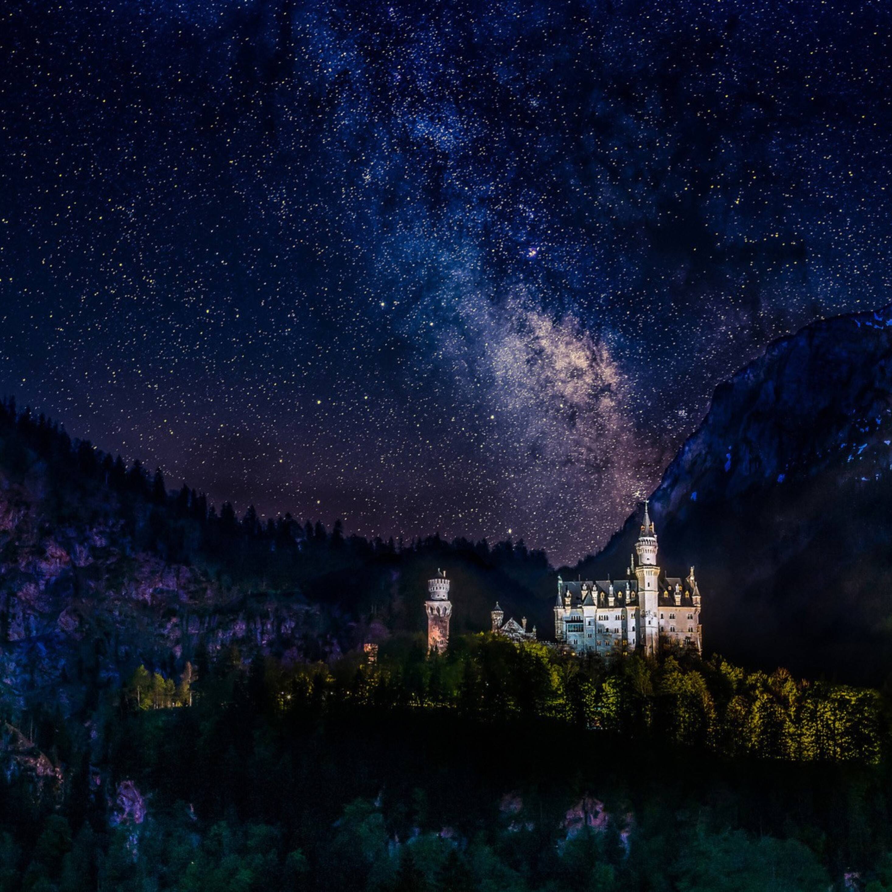 A castle is lit up under the night sky - Castle