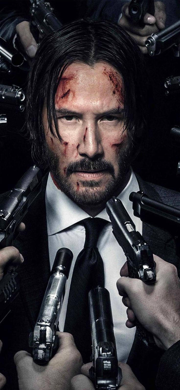 Keanu Reeves as John Wick holding a gun in each hand with blood on his face - John Wick