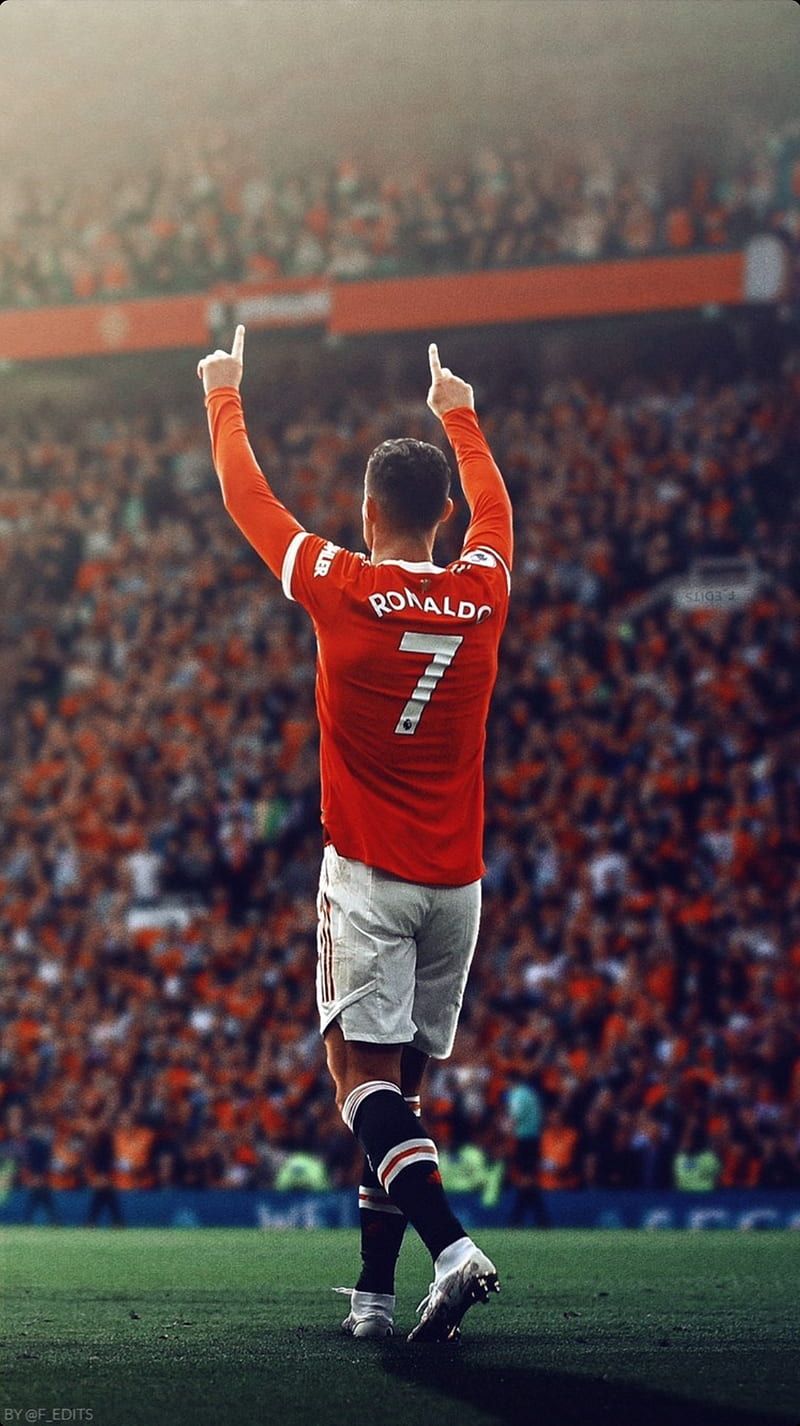 Cristiano Ronaldo celebrating after scoring a goal for Manchester United in front of a full stadium - Cristiano Ronaldo