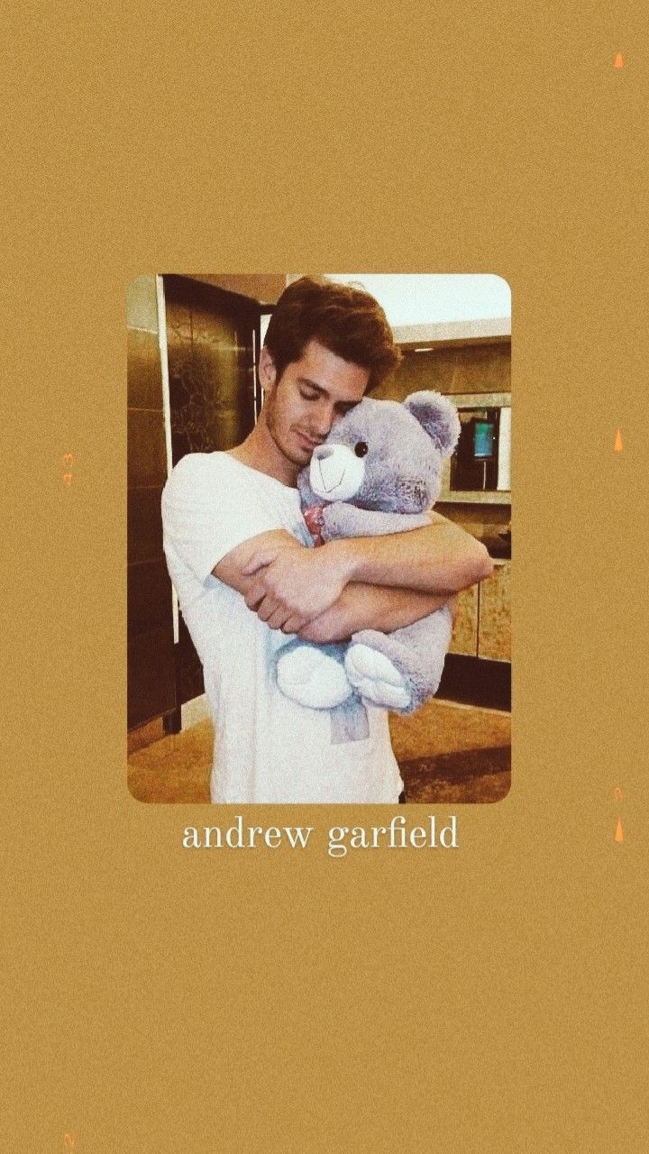 A man holding a teddy bear - Andrew Garfield