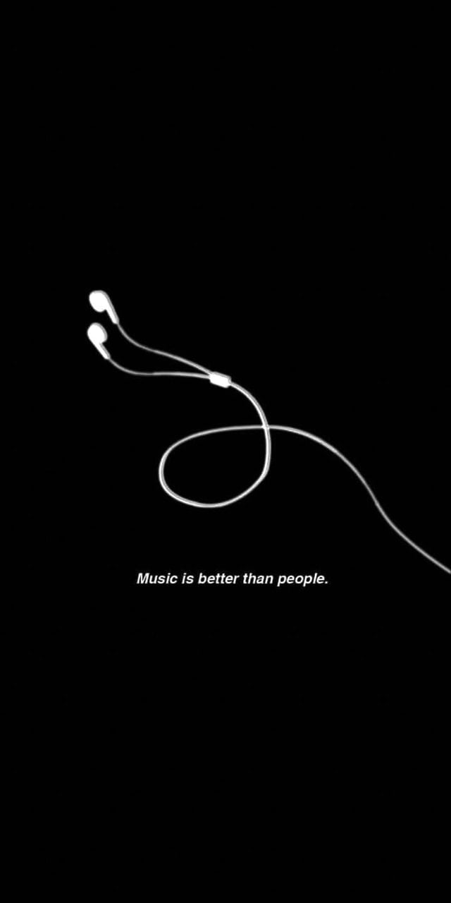 A black and white image of headphones on the ground - Black phone, music, dark